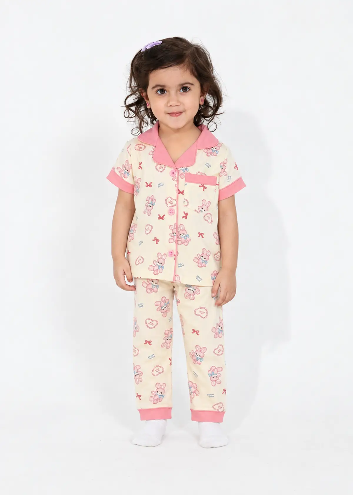 Girl wearing Rosy Bunny half sleeve nightwear, cream with a pink collar and bunny and bow print