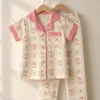 Blush Ballerina half sleeve nightwear for girls, cream top and pants with pink trim on hangers