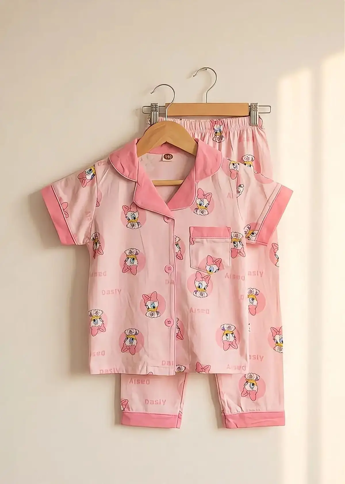 Pink Daisy half sleeve nightwear for girls, pink top and pants with duck print on hangers