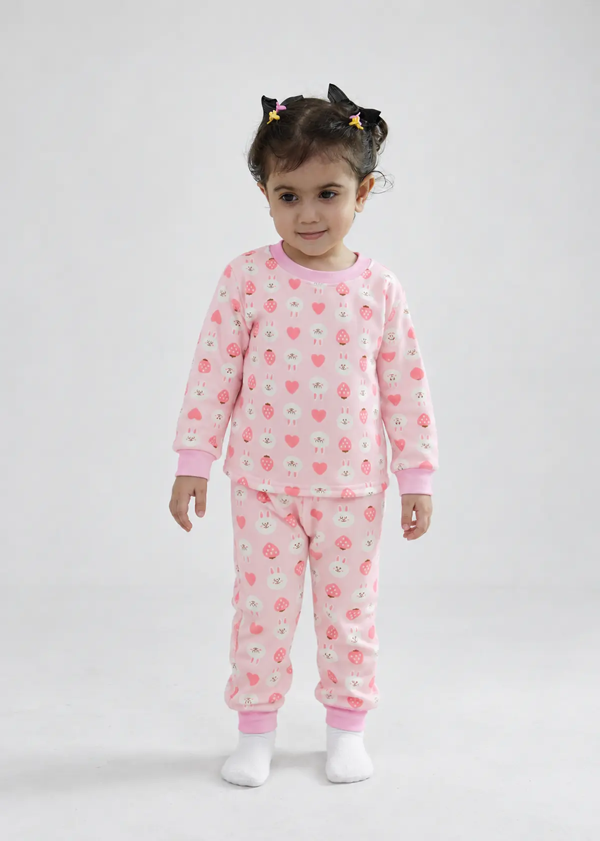 Girl wearing Cuddly Strawberry Nightwear, pink fleece lined set